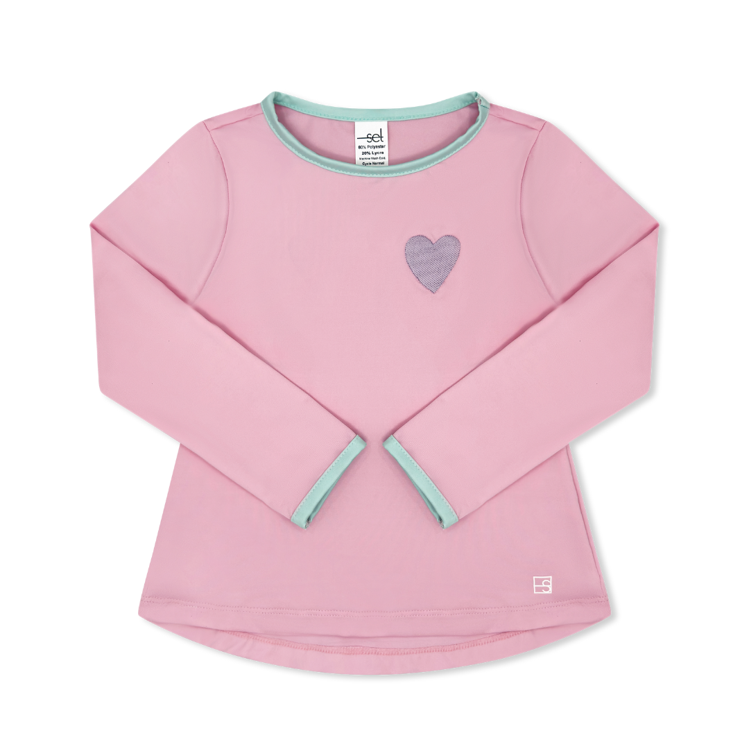 Pink long-sleeve shirt with a heart design on a white background